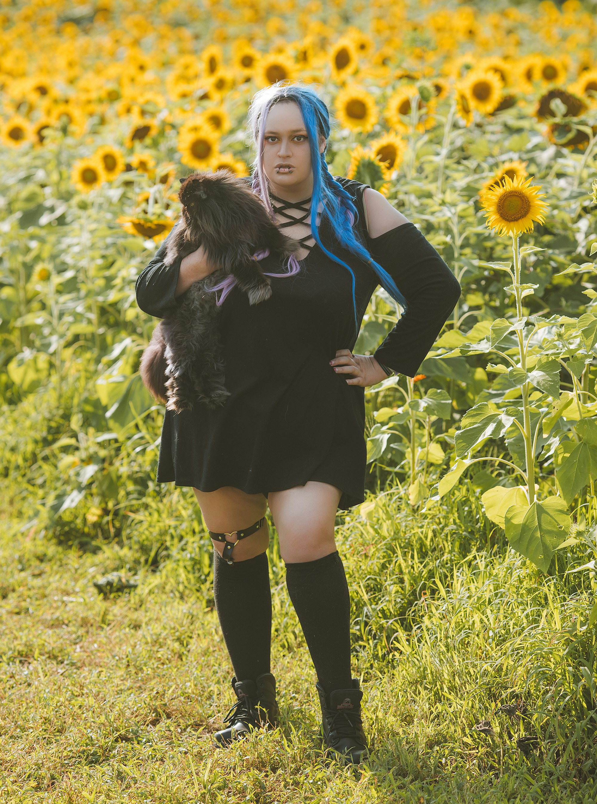 woman in black long sleeve dress standing on green grass field during daytime